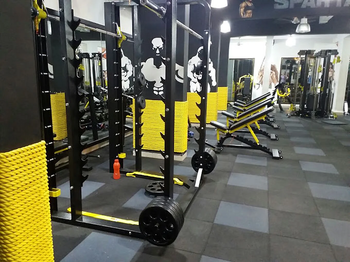 Strength floor with squat racks and adjustable benches
