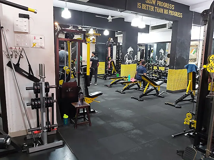 Main training hall with benches and dumbbell racks at SPARTANS